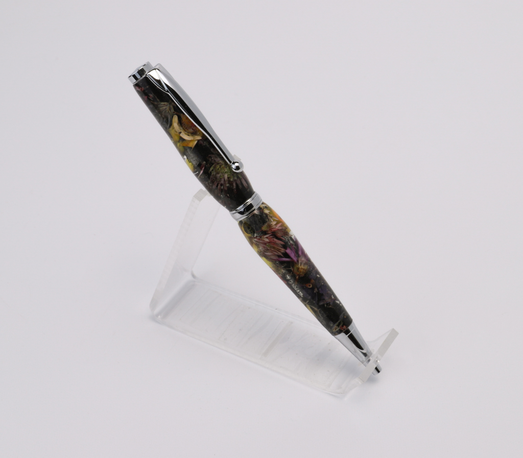 A black flower pen sitting sideways on a white background